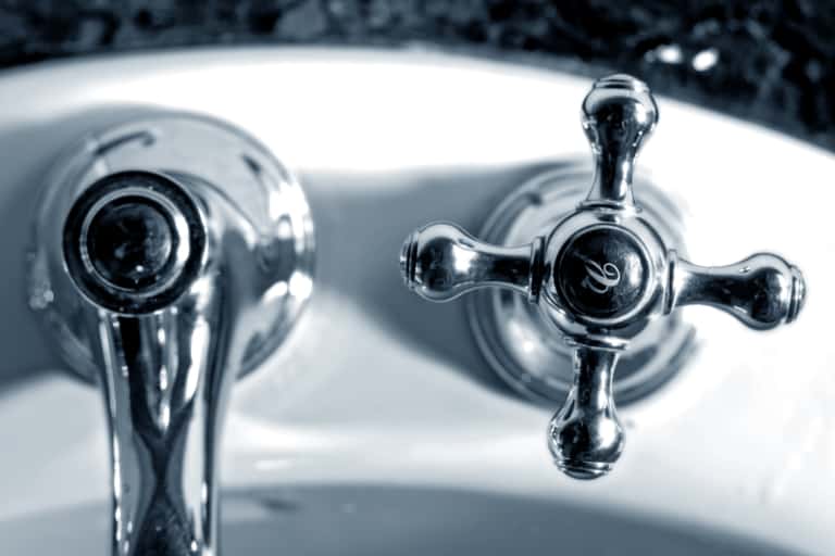 Water taps in bathroom closeup.