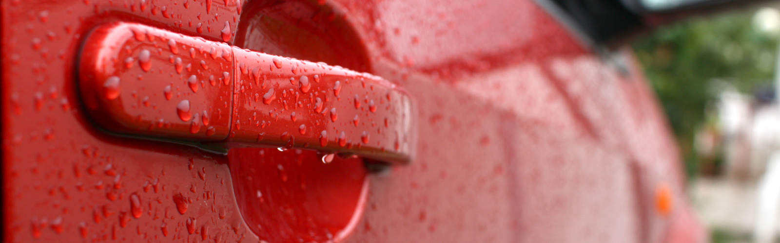 Water drops on red car after car wash.